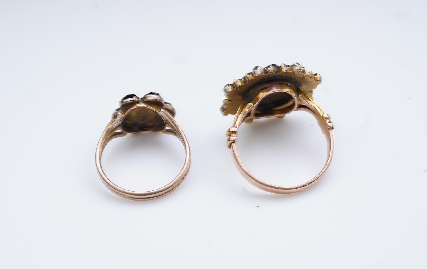 A suite of garnet and paste jewellery, comprising: a brooch, 5cm diameter; a bangle, inner circumference 16cm; two rings, sizes I and M; a pair of earrings, and a single earring, each set with rose-cut garnets; and a pai